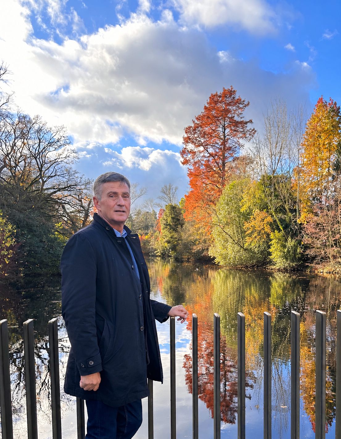 Alper beside a pond on an autumn walk